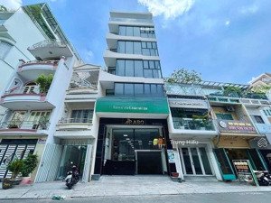 tòa nhà góc 2 mặt tiền đường - ngay ngã tư lê quang định - phan văn trị . hầm 8 tầng thang máy.